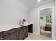 Upstairs kitchenette with sink, wooden cabinets, and a view into the bedroom at 428 Crayton Oak Dr, Cary, NC 27519