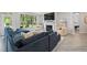 Bright living room with fireplace, plush seating, and large windows showcasing outdoor views at 428 Crayton Oak Dr, Cary, NC 27519