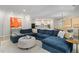 Open-concept living space with a large sectional sofa, modern decor, and an adjacent dining area at 428 Crayton Oak Dr, Cary, NC 27519