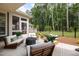 Inviting patio with comfortable seating, a modern fire pit, and a view of the serene backyard at 428 Crayton Oak Dr, Cary, NC 27519