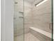 Glass enclosed shower featuring a built-in bench and modern tile design at 428 Crayton Oak Dr, Cary, NC 27519