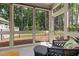 Bright sunroom featuring comfortable wicker seating and scenic backyard views through large windows at 428 Crayton Oak Dr, Cary, NC 27519
