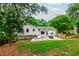 Back exterior of the home showing the patio, lawn and surrounding garden beds at 433 Rosehaven Dr, Raleigh, NC 27609