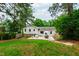 Back exterior of the home showing the patio, lawn and surrounding landscape at 433 Rosehaven Dr, Raleigh, NC 27609