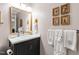 Well-lit bathroom featuring a dark vanity with white countertop and decorative towels at 433 Rosehaven Dr, Raleigh, NC 27609