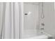 Bright white bathroom with shower and tub combo, featuring modern fixtures and a classic design at 433 Rosehaven Dr, Raleigh, NC 27609
