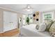 Bright bedroom features hardwood floors and ensuite bathroom with a double door closet at 433 Rosehaven Dr, Raleigh, NC 27609