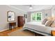 Bedroom with neutral walls, hardwood floors, large window and natural light at 433 Rosehaven Dr, Raleigh, NC 27609