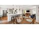 Bright open kitchen with white cabinetry, stainless steel appliances, and a view into the living area at 433 Rosehaven Dr, Raleigh, NC 27609