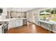 Bright kitchen with stainless steel appliances, white cabinetry, and view to backyard at 433 Rosehaven Dr, Raleigh, NC 27609