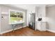 Bright kitchen with stainless steel appliances, white cabinetry, and view to backyard at 433 Rosehaven Dr, Raleigh, NC 27609