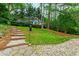 Beautiful landscaping with a stone staircase and birdhouse in the backyard at 433 Rosehaven Dr, Raleigh, NC 27609