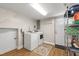 Well-organized laundry room with modern washer and dryer, storage shelves and access to an exterior door at 433 Rosehaven Dr, Raleigh, NC 27609