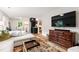 Open-concept living room features a large TV, stylish furnishings, and views into an adjacent space at 433 Rosehaven Dr, Raleigh, NC 27609