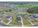 Aerial view of neighborhood featuring a pond and homes with spacious lawns at 450 S Parliament Way, Clayton, NC 27520