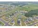 Aerial view of community featuring pond and some homes with private backyard pools at 450 S Parliament Way, Clayton, NC 27520