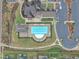 Aerial view of community pool area with ample seating, lush landscaping, and parking at 450 S Parliament Way, Clayton, NC 27520