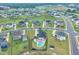 Aerial view of neighborhood with lush green lawns, mature trees, and a private backyard pool at 450 S Parliament Way, Clayton, NC 27520