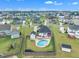 Aerial view of a private backyard with an in-ground pool, patio seating, and a wooden fence within a friendly neighborhood at 450 S Parliament Way, Clayton, NC 27520