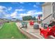 Serene backyard with lush lawn, patio seating, and partial view of community pool, perfect for gatherings at 450 S Parliament Way, Clayton, NC 27520