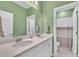 Bathroom with white cabinets, double sinks, and a shower and tub combo at 450 S Parliament Way, Clayton, NC 27520