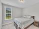 Cozy bedroom with a queen-size bed, neutral walls, and a sunny window at 450 S Parliament Way, Clayton, NC 27520