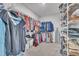 Spacious walk-in closet with ample storage and organization racks for clothes and shoes at 450 S Parliament Way, Clayton, NC 27520