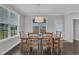 Well-lit dining area with a wooden table, matching chairs and views from the window at 450 S Parliament Way, Clayton, NC 27520