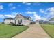 Well-maintained home featuring a spacious three-car garage, a long driveway, and an extra detached garage space at 450 S Parliament Way, Clayton, NC 27520