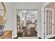Open foyer showcasing dark wood floors and an open layout extending into the living and dining areas with natural light at 450 S Parliament Way, Clayton, NC 27520