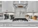 Close-up view of kitchen details highlighting a gas range and subway tile backsplash at 450 S Parliament Way, Clayton, NC 27520