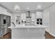 Elegant kitchen featuring stainless steel appliances, white cabinetry, and an island at 450 S Parliament Way, Clayton, NC 27520
