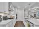 Modern kitchen with white cabinetry, stainless steel appliances, a gas range and hardwood floors at 450 S Parliament Way, Clayton, NC 27520