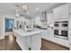 Bright kitchen features an island, modern appliances, and stylish pendant lighting at 450 S Parliament Way, Clayton, NC 27520