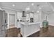 Modern kitchen with white cabinets, stainless steel appliances, and a kitchen island at 450 S Parliament Way, Clayton, NC 27520