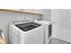 Well-lit laundry room with Samsung washer and dryer, plus white cabinets and door at 450 S Parliament Way, Clayton, NC 27520