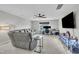 Living room featuring a sectional sofa, ceiling fan, and entertainment center at 450 S Parliament Way, Clayton, NC 27520