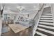 Spacious living room featuring a gray sofa, a fireplace, and a staircase at 450 S Parliament Way, Clayton, NC 27520