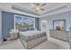 Serene main bedroom features tray ceilings, cool blue walls, plush carpeting, and abundant natural light at 450 S Parliament Way, Clayton, NC 27520
