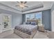 Light-filled main bedroom with tray ceilings, backyard views and ceiling fan at 450 S Parliament Way, Clayton, NC 27520