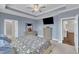 Spacious main bedroom featuring en-suite bathroom, tray ceilings, and ample storage space at 450 S Parliament Way, Clayton, NC 27520