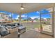 Relaxing screened-in patio with plush seating, ceiling fan, and neighborhood views, ideal for outdoor living at 450 S Parliament Way, Clayton, NC 27520