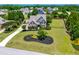 Aerial view shows a beautifully landscaped yard and curb appeal of a home in a neighborhood setting at 4621 Basilica Dr, Holly Springs, NC 27540