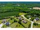 An aerial view shows a home surrounded by mature trees and manicured lawns in a well-kept neighborhood at 4621 Basilica Dr, Holly Springs, NC 27540