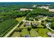 Aerial view of a tree-lined neighborhood featuring homes with manicured lawns and mature trees at 4621 Basilica Dr, Holly Springs, NC 27540