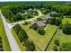 Aerial view of a landscaped yard surrounding a well-maintained home, complete with a fenced backyard and mature trees at 4621 Basilica Dr, Holly Springs, NC 27540