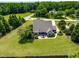 Aerial view of a well-manicured backyard with a patio seating area and lush green lawn at 4621 Basilica Dr, Holly Springs, NC 27540