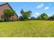 Expansive backyard with lush green grass, mature trees, and beautiful landscaping, perfect for outdoor activities at 4621 Basilica Dr, Holly Springs, NC 27540