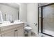 Neutral bathroom featuring single vanity, framed mirror, and glass shower with tiled surround at 4621 Basilica Dr, Holly Springs, NC 27540