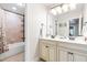 Bathroom features a double vanity and a tub/shower combo with tiled walls at 4621 Basilica Dr, Holly Springs, NC 27540